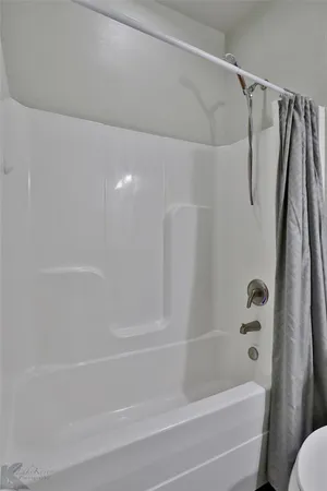 a bathroom with a shower and a bath tub