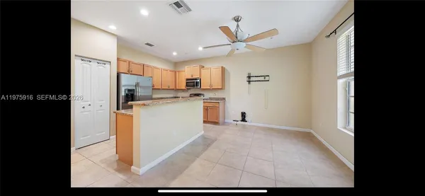 a view of a kitchen with a sink and dishwasher a refrigerator with wooden floor