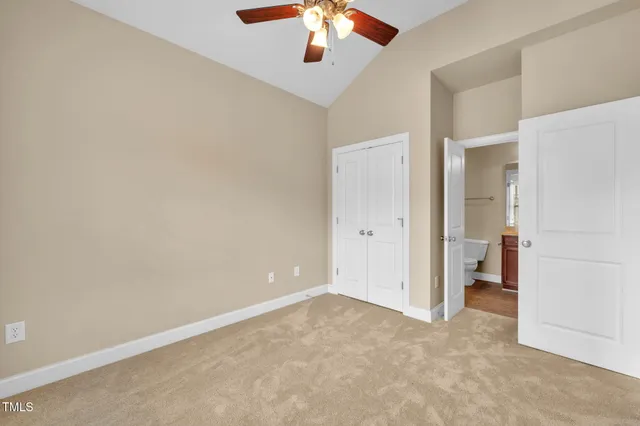 an empty room with fan and entrance