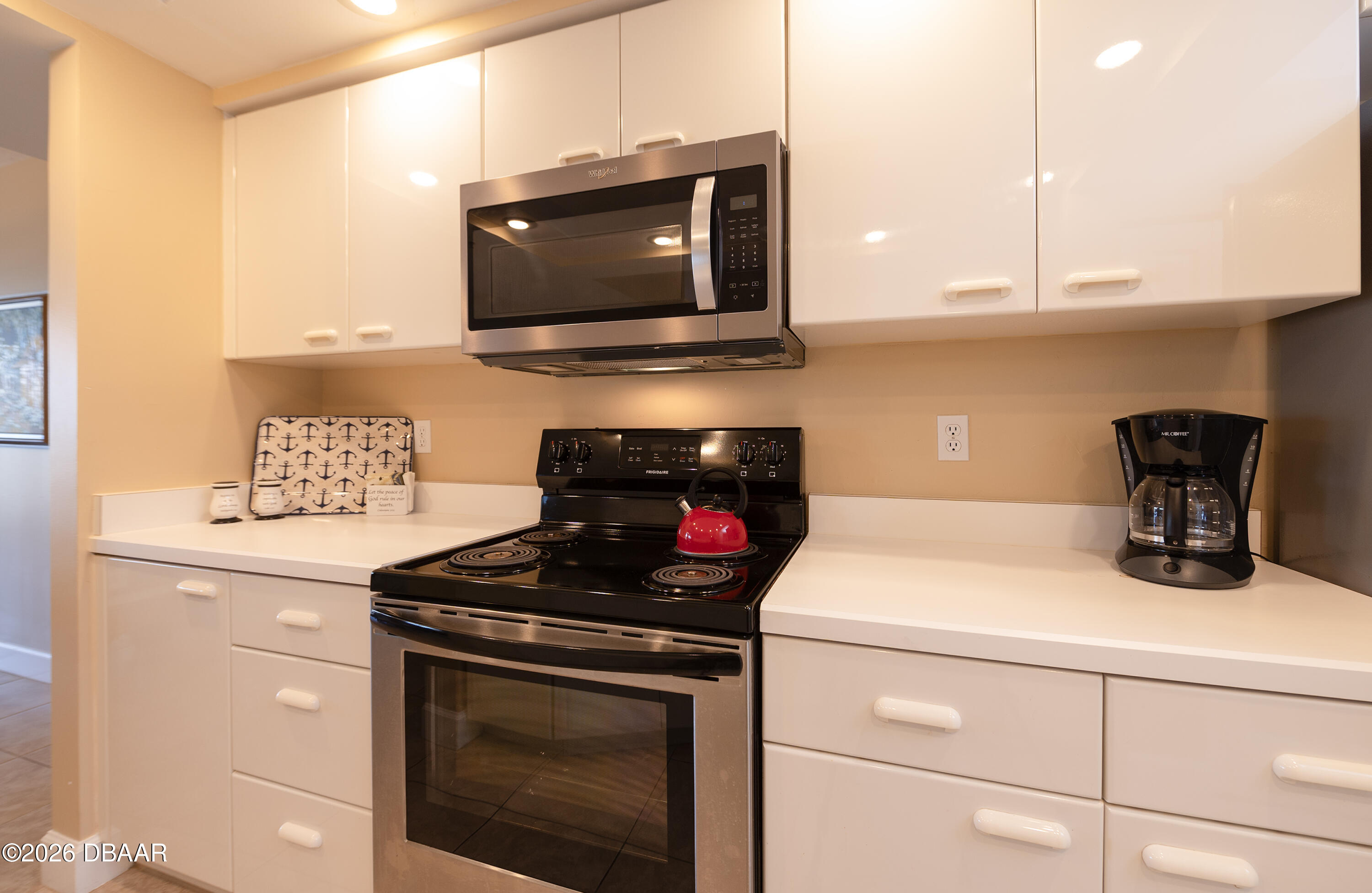 4575 South Atlantic Avenue, Unit 6701 Ponce Inlet, FL 32127 - Photo 11 of 35 a kitchen with a stove and a microwave