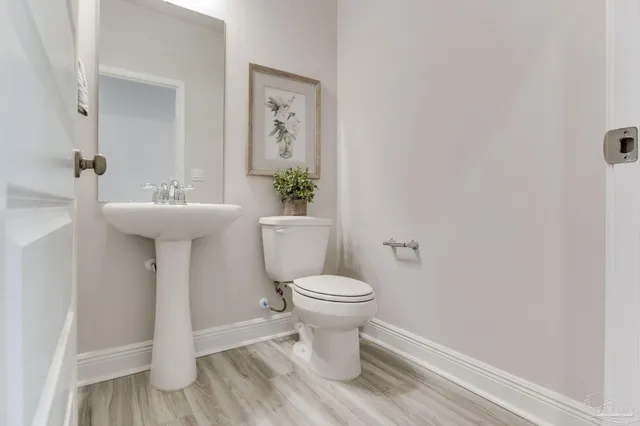 a bathroom with a sink toilet and a mirror