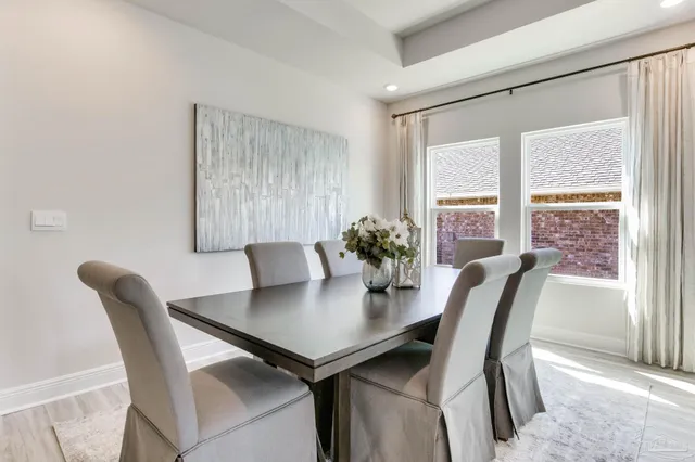 a view of a dining room with furniture and window