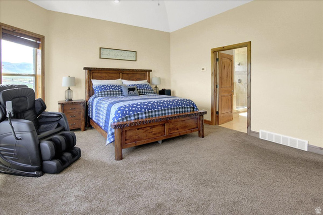 667 Hardscrabble Road Morgan, UT 84050 - Photo 24 of 51 Master Bedroom featuring light colored carpet, lofted ceiling, and ensuite bath