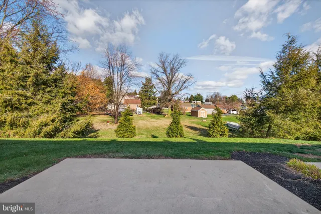 a front view of a house with a garden and patio