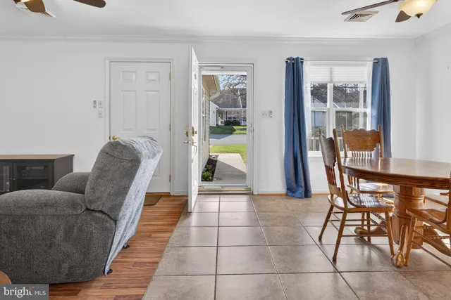a living room with furniture and a dining table