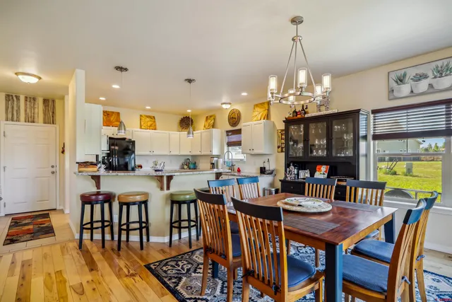 a view of a dining room with furniture and chandelier