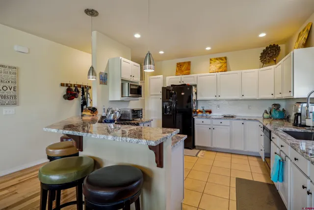 a kitchen with refrigerator and cabinets