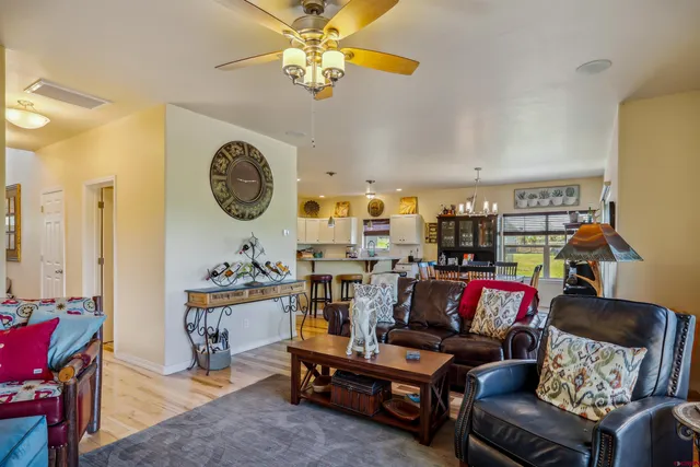 a living room with furniture a rug and a wall painting