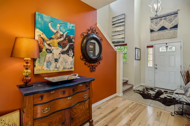 a bedroom with a bed and a wall painting