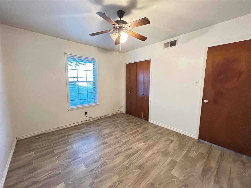409 Royal Street, Unit 1 Athens, TX 75751 - Photo 11 of 14 wooden floor in an empty room with a window