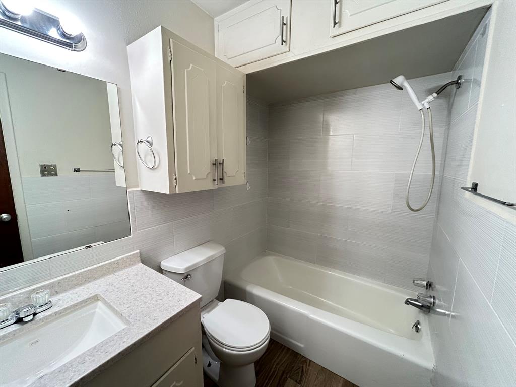 409 Royal Street, Unit 1 Athens, TX 75751 - Photo 13 of 14 a bathroom with a sink a toilet and shower