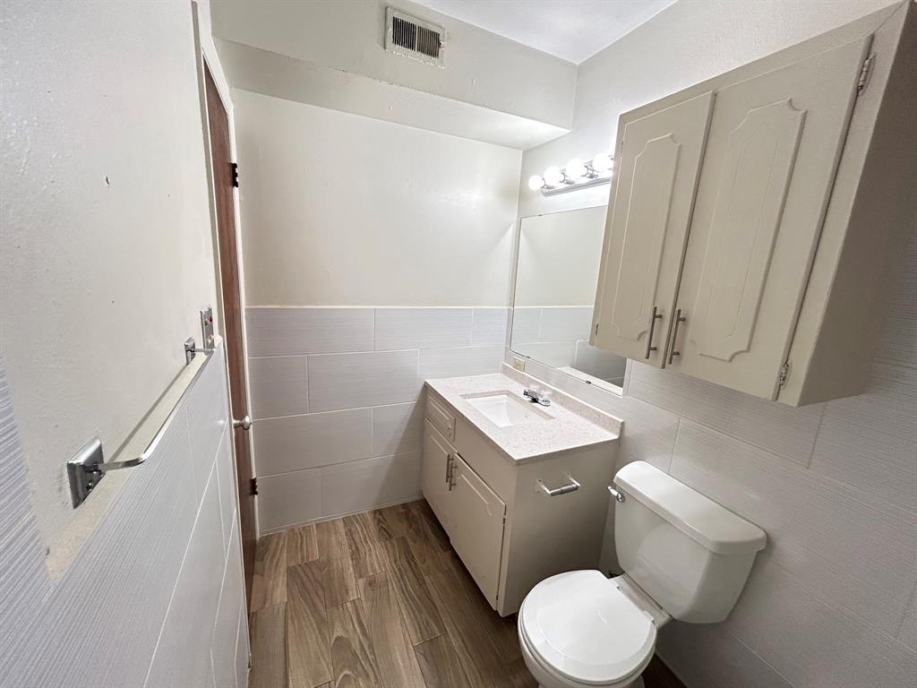 409 Royal Street, Unit 1 Athens, TX 75751 - Photo 14 of 14 a bathroom with a granite countertop sink toilet and shower