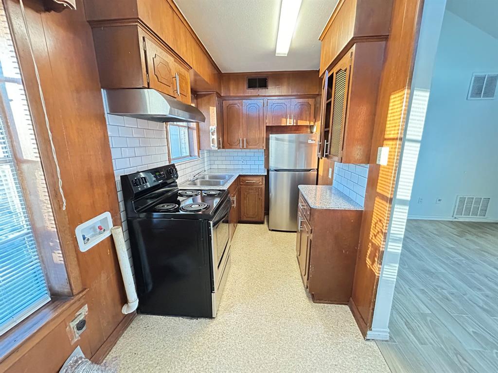 409 Royal Street, Unit 1 Athens, TX 75751 - Photo 6 of 14 a view of kitchen with furniture and wooden floor