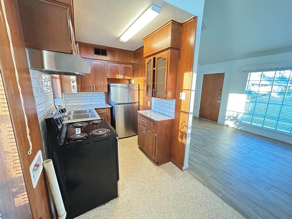 409 Royal Street, Unit 1 Athens, TX 75751 - Photo 7 of 14 a view of kitchen with furniture and wooden floor