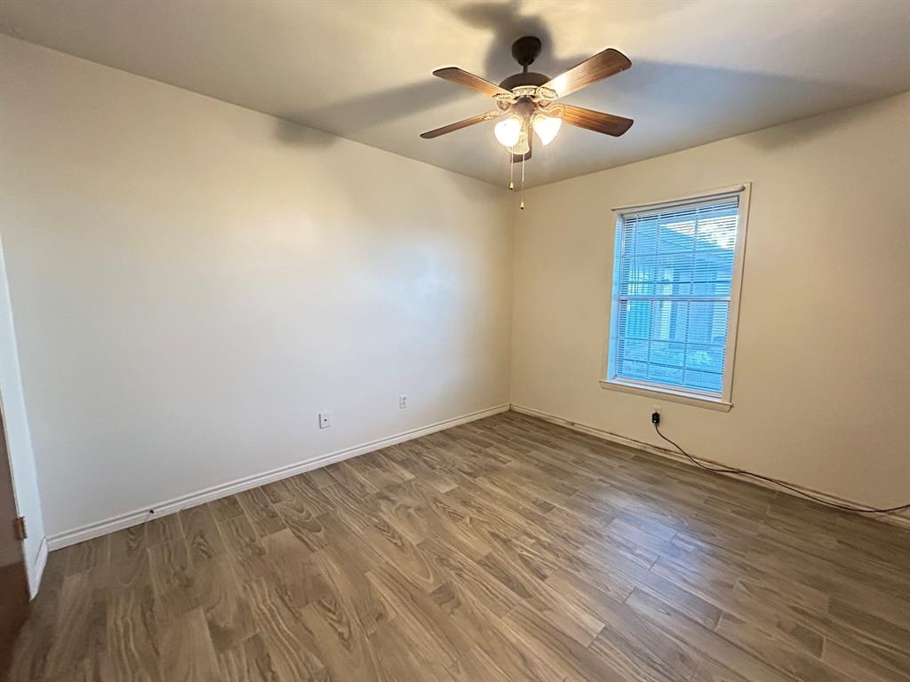 409 Royal Street, Unit 1 Athens, TX 75751 - Photo 8 of 14 a view of an empty room with a chandelier fan