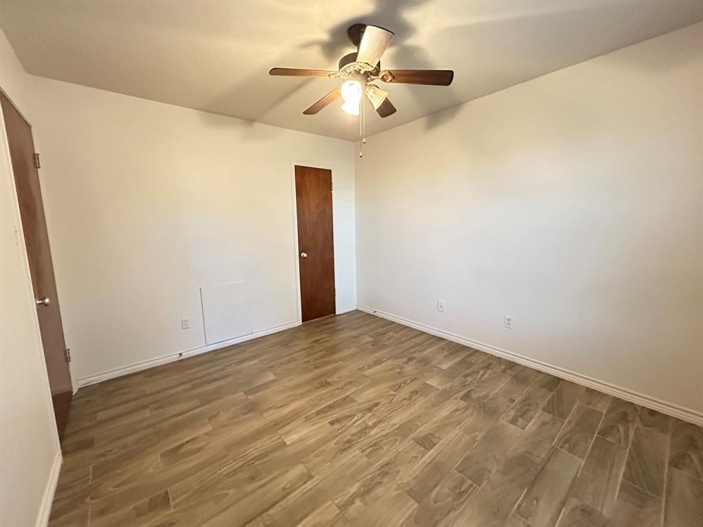 409 Royal Street, Unit 1 Athens, TX 75751 - Photo 9 of 14 a view of a room with a ceiling fan