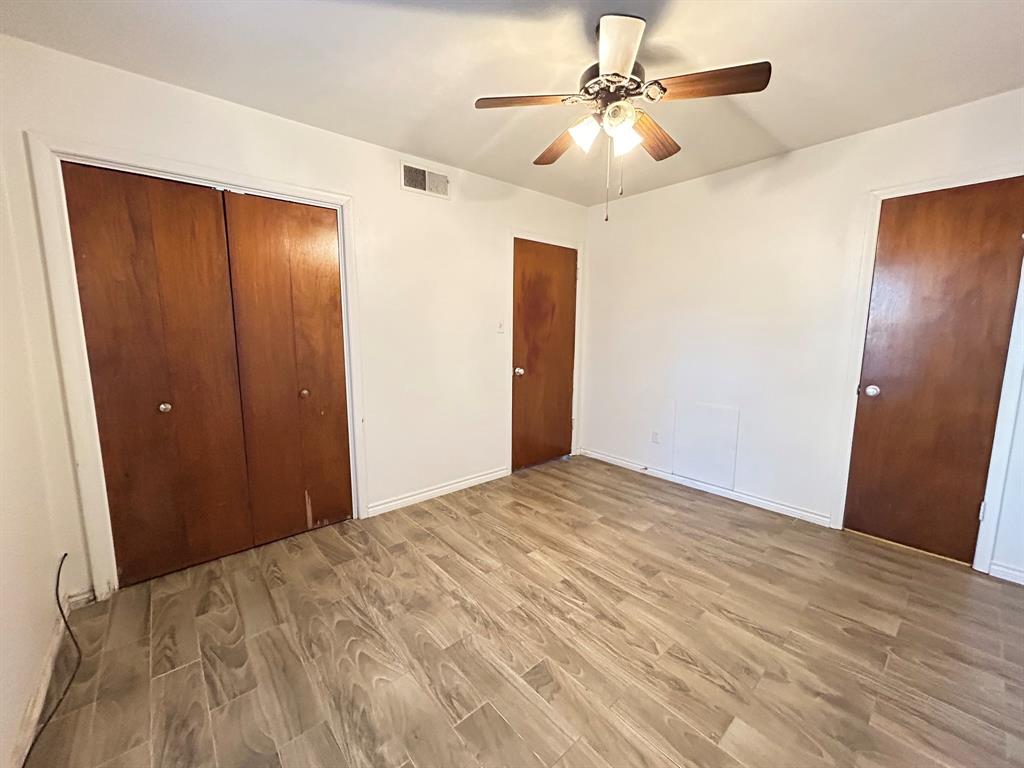 409 Royal Street, Unit 1 Athens, TX 75751 - Photo 10 of 14 a view of an empty room with a chandelier fan