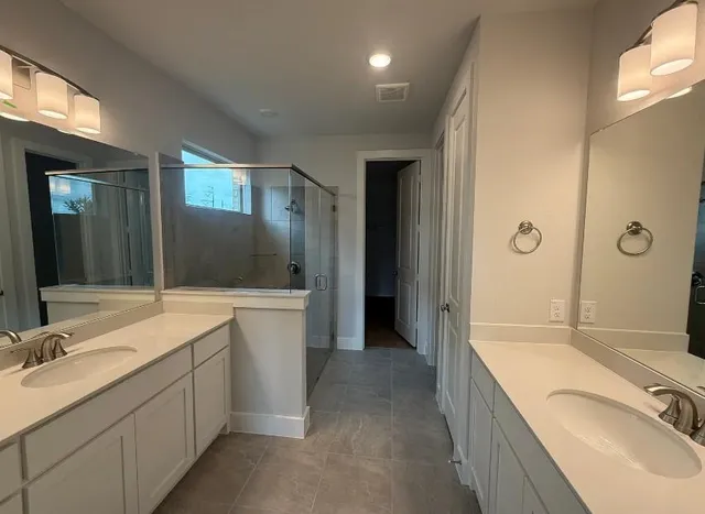 a bathroom with a granite countertop tub sink double vanity granite tub shower and mirror