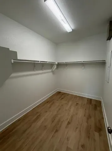 a view of a room with wooden floor