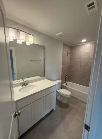 a bathroom with a double vanity sink toilet and shower