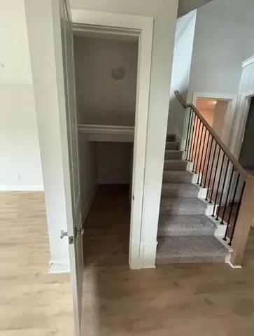a view of entryway and hall with wooden floor