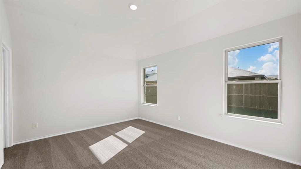1663 Blaire Drive Tyler, TX 75704 - Photo 18 of 26 Spacious room featuring neutral paint, gray carpeting, two windows, and a recessed ceiling light