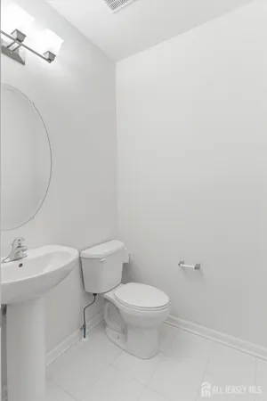 a white toilet sitting next to a bathroom sink
