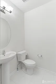 a white toilet sitting next to a bathroom sink