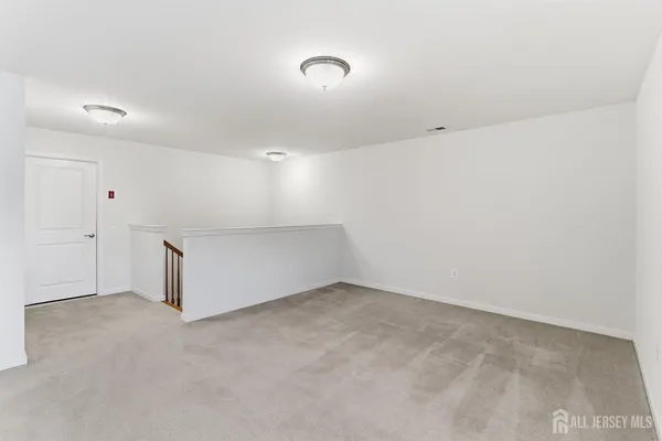 a view of an empty room and wooden floor