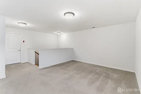 a view of an empty room and wooden floor