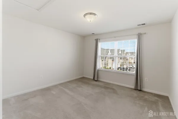 a bathroom with a sink a toilet a mirror and shower
