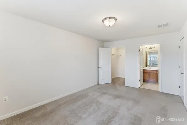 a bathroom with a toilet a sink a mirror a bathtub and vanity