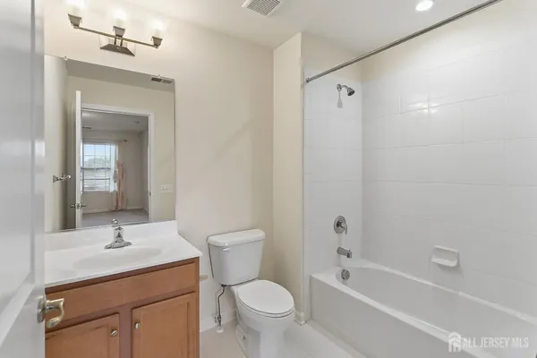 a view of a hallway with wooden floor and entryway