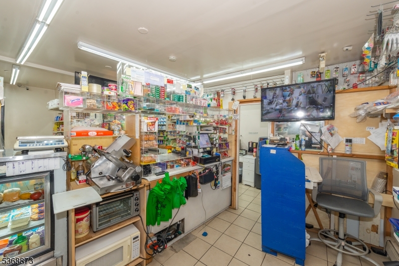 609 Madison Avenue, Unit 2 Paterson, NJ 07514 - Photo 11 of 43 a room filled with furniture and a kitchen view