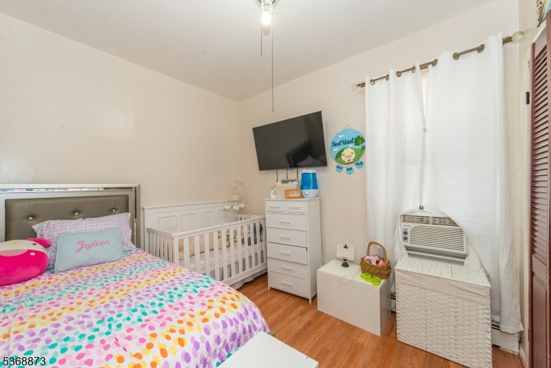 609 Madison Avenue, Unit 2 Paterson, NJ 07514 - Photo 17 of 43 a bedroom with a bed and a flat screen tv