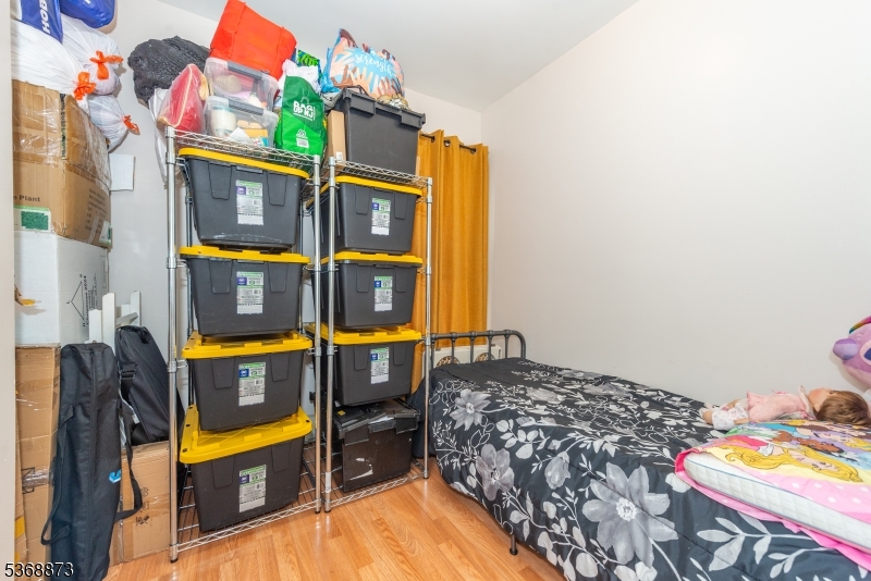 609 Madison Avenue, Unit 2 Paterson, NJ 07514 - Photo 18 of 43 a bed sitting in a bedroom next to a building