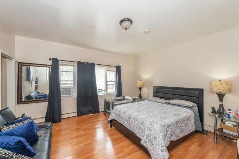609 Madison Avenue, Unit 2 Paterson, NJ 07514 - Photo 21 of 43 a bedroom with a large bed and a window