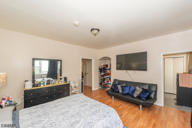 609 Madison Avenue, Unit 2 Paterson, NJ 07514 - Photo 23 of 43 a bedroom with furniture and a flat screen tv