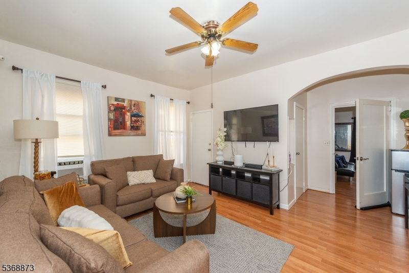 609 Madison Avenue, Unit 2 Paterson, NJ 07514 - Photo 24 of 43 a living room with furniture and a flat screen tv