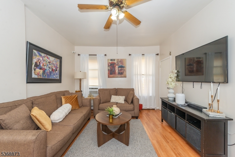 609 Madison Avenue, Unit 2 Paterson, NJ 07514 - Photo 25 of 43 a living room with furniture and a flat screen tv