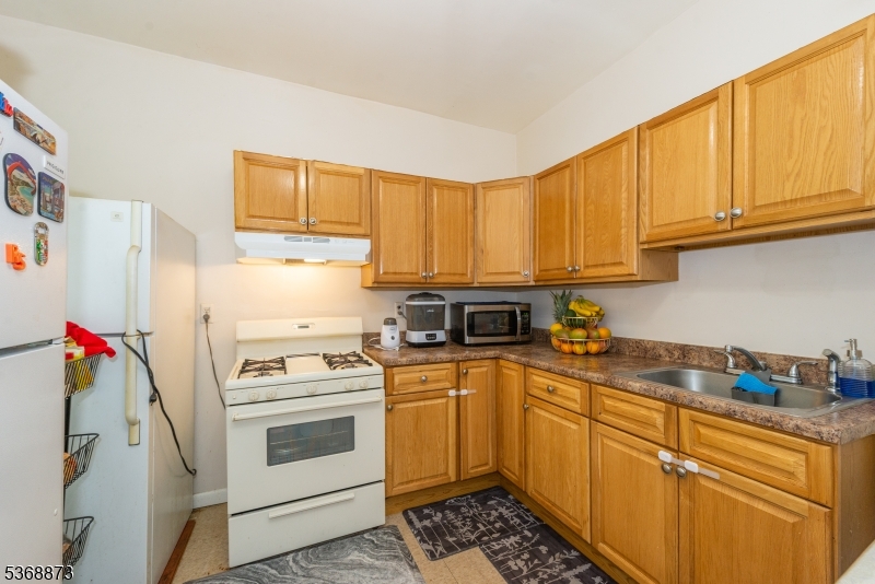 609 Madison Avenue, Unit 2 Paterson, NJ 07514 - Photo 28 of 43 a kitchen with a white cabinets and white appliances