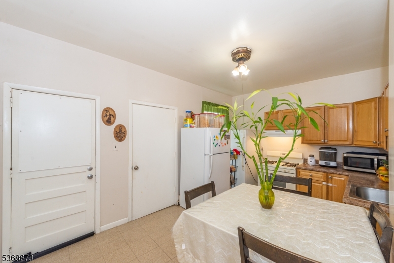 609 Madison Avenue, Unit 2 Paterson, NJ 07514 - Photo 29 of 43 a kitchen with granite countertop a sink stainless steel appliances and cabinets