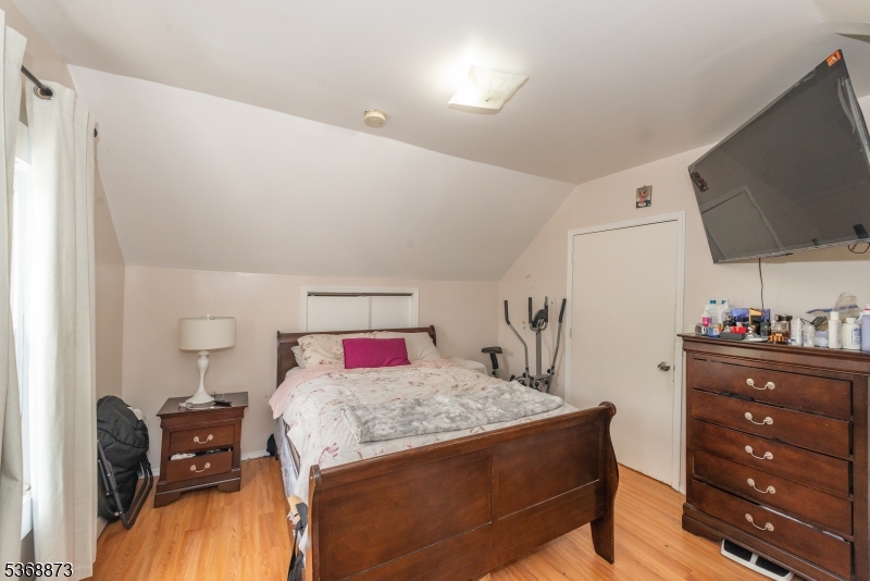 609 Madison Avenue, Unit 2 Paterson, NJ 07514 - Photo 32 of 43 a living room with furniture and a flat screen tv