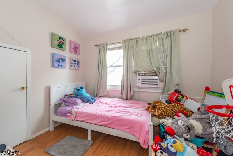 609 Madison Avenue, Unit 2 Paterson, NJ 07514 - Photo 34 of 43 a bedroom with a bed and a window