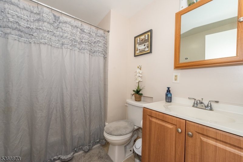 609 Madison Avenue, Unit 2 Paterson, NJ 07514 - Photo 35 of 43 a bathroom with a sink a toilet and a mirror