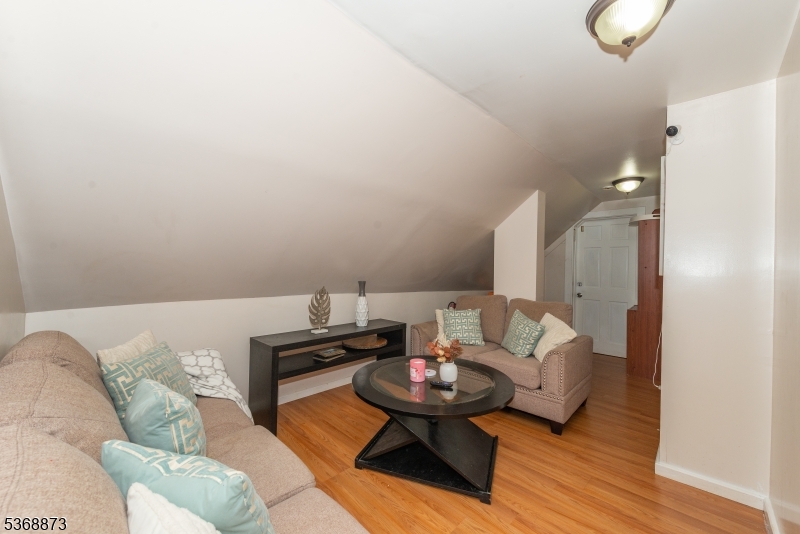 609 Madison Avenue, Unit 2 Paterson, NJ 07514 - Photo 42 of 43 a living room with furniture and wooden floor