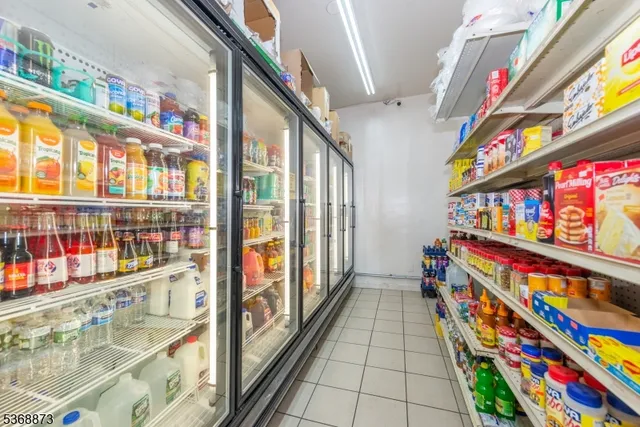 a room filled with furniture and a kitchen view