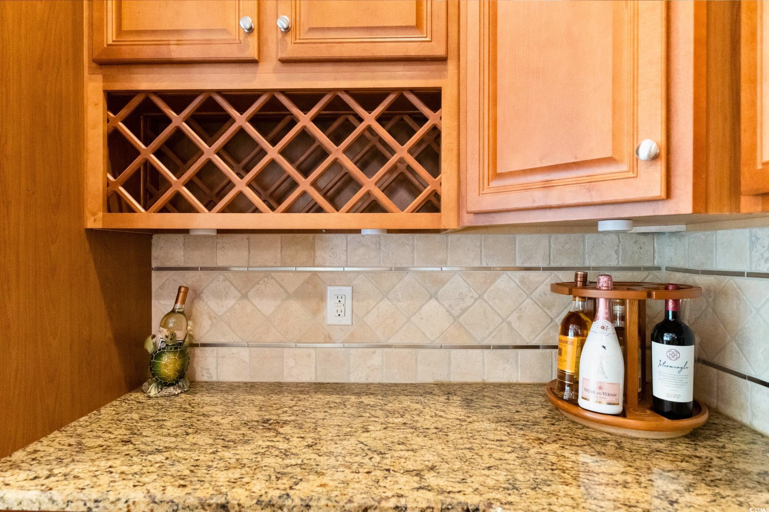 9100 Fountain Street Southwest Calabash, NC 28467 - Photo 12 of 40 Interior details with a dry bar, backsplash, and light stone countertops