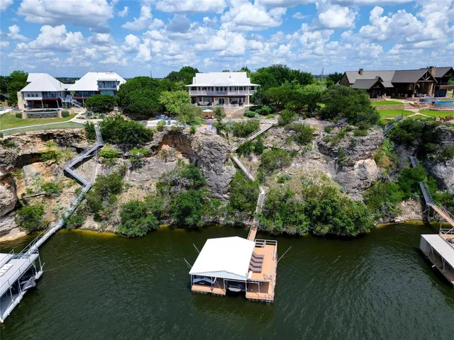 an aerial view of a house with a garden and lake view