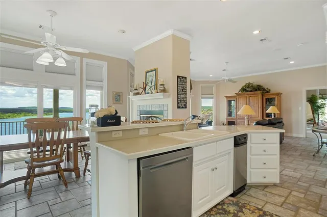 a kitchen with a stove a sink and chairs
